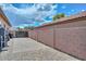 Spacious side yard with brick-paved area and high privacy wall, perfect for storage or additional outdoor space at 4306 W Summerside Rd, Laveen, AZ 85339
