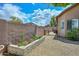 Well-maintained side yard featuring a stone garden, a gravel path, and privacy fencing, offering a serene outdoor space at 4306 W Summerside Rd, Laveen, AZ 85339
