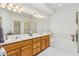 Bright bathroom featuring double sinks, a large mirror, and a separate shower and soaking tub at 4722 E Casey Ln, Cave Creek, AZ 85331