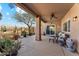 Outdoor patio featuring a seating area, ceiling fan, and desert plants at 4722 E Casey Ln, Cave Creek, AZ 85331