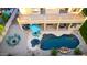 Aerial view of a backyard featuring a pool, a fire pit with chairs, and outdoor dining areas at 4812 S Windstream Pl, Chandler, AZ 85249
