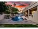 Sprawling backyard with a pool, covered patio, and ample seating, creating an entertainer's paradise at 4812 S Windstream Pl, Chandler, AZ 85249