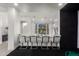Modern bar with seating, open to the main house and the golf simulator room at 4812 S Windstream Pl, Chandler, AZ 85249