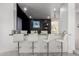 Modern bar with marble countertop and sleek white stools, perfect for entertaining guests at 4812 S Windstream Pl, Chandler, AZ 85249