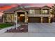Beautiful two-story home showcasing a three-car garage and manicured front yard under a colorful sky at 4812 S Windstream Pl, Chandler, AZ 85249