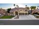 Charming two-story home featuring a well-manicured lawn, a three-car garage, and elegant architectural details at 4812 S Windstream Pl, Chandler, AZ 85249