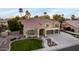 Charming two-story home with manicured lawn, mature trees, and a spacious three-car garage at 4812 S Windstream Pl, Chandler, AZ 85249