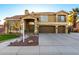 Elegant two-story home with a three-car garage, attractive landscaping, and a welcoming entrance at 4812 S Windstream Pl, Chandler, AZ 85249