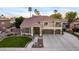 Charming two-story home featuring a well-manicured lawn, a three-car garage, and elegant architectural details at 4812 S Windstream Pl, Chandler, AZ 85249