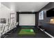 Fun game room featuring a golf simulator, bar seating and custom art at 4812 S Windstream Pl, Chandler, AZ 85249