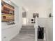 Bright hallway featuring light gray stone flooring, white walls, and modern artistic decor at 4812 S Windstream Pl, Chandler, AZ 85249