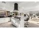 Spacious kitchen with white cabinets, a center island with bar stools, and stainless steel appliances at 4812 S Windstream Pl, Chandler, AZ 85249