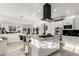 Modern kitchen with white cabinets, a center island with bar stools, and stainless steel appliances at 4812 S Windstream Pl, Chandler, AZ 85249