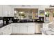 Bright kitchen featuring white cabinets, stainless steel appliances, and modern design at 4812 S Windstream Pl, Chandler, AZ 85249