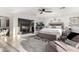 Main bedroom features a fireplace, king bed, stylish decor, chaise lounge and bright natural light at 4812 S Windstream Pl, Chandler, AZ 85249