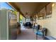 Inviting covered patio with stainless grill, ceiling fans, and outdoor seating for entertaining guests at 4812 S Windstream Pl, Chandler, AZ 85249