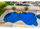 Inviting pool with waterfall feature and a beautifully landscaped patio for relaxation and enjoyment at 4812 S Windstream Pl, Chandler, AZ 85249