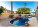 Backyard oasis with a stunning pool, rock waterfall feature, and relaxing lounge area at 4812 S Windstream Pl, Chandler, AZ 85249