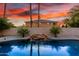 Beautiful pool with a rock waterfall feature and tropical landscaping, perfect for relaxation at 4812 S Windstream Pl, Chandler, AZ 85249