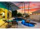 Beautiful backyard pool area with waterfall feature, lounge chairs, and desert landscaping at 4812 S Windstream Pl, Chandler, AZ 85249