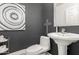 Elegant powder room with modern fixtures, dark walls, and decorative accents at 4812 S Windstream Pl, Chandler, AZ 85249