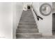 Elegant staircase with sleek railings and tile steps offers a grand entrance to the upper level at 4812 S Windstream Pl, Chandler, AZ 85249