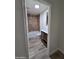 A full bathroom with a wood vanity, a toilet, and a tiled shower and tub at 4924 W Catalina Dr, Phoenix, AZ 85031