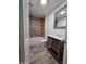 Bathroom featuring a wood vanity, white countertops and cabinet, a toilet, and tile backsplash at 4924 W Catalina Dr, Phoenix, AZ 85031