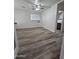 Spacious bedroom with wood floors, ceiling fan, and bright natural light from a window at 4924 W Catalina Dr, Phoenix, AZ 85031