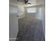 This bedroom features plush carpeting, a ceiling fan, and a bright window at 4924 W Catalina Dr, Phoenix, AZ 85031