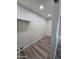 A well-lit closet features modern wood floors and white paneling with a shelf and hanging rod at 4924 W Catalina Dr, Phoenix, AZ 85031
