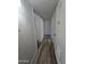 Hallway featuring neutral paint and modern wood floors leading to rooms with white doors at 4924 W Catalina Dr, Phoenix, AZ 85031