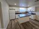 Renovated kitchen featuring white cabinets, a center island, and stainless appliances at 4924 W Catalina Dr, Phoenix, AZ 85031