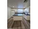 Updated kitchen features white cabinets, an island, and stainless steel appliances at 4924 W Catalina Dr, Phoenix, AZ 85031