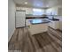Bright, airy kitchen with white cabinets, a center island, and stainless appliances at 4924 W Catalina Dr, Phoenix, AZ 85031