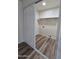 Compact laundry room with shelving and updated flooring at 4924 W Catalina Dr, Phoenix, AZ 85031