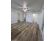 Spacious living room with wood-look floors, white walls, and multiple doorways at 4924 W Catalina Dr, Phoenix, AZ 85031