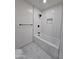 Elegant bathroom with a soaking tub, sleek black fixtures, and stylish white subway tile at 5201 N 61St Dr, Glendale, AZ 85301