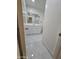 Bathroom features a vanity with white cabinets, marble tile flooring, and large mirror at 5201 N 61St Dr, Glendale, AZ 85301