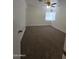 Bedroom features a ceiling fan, window with blinds, and neutral carpet flooring at 5201 N 61St Dr, Glendale, AZ 85301