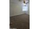 Cozy bedroom with plush carpet, ceiling fan, and bright window at 5201 N 61St Dr, Glendale, AZ 85301