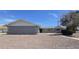 Charming single-story home features a gray exterior, well-maintained landscape, and a clear blue sky at 5201 N 61St Dr, Glendale, AZ 85301