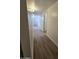 Hallway featuring wood-look floors leading to the rest of the home's bright interior at 5201 N 61St Dr, Glendale, AZ 85301