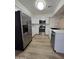 Updated kitchen with stainless steel appliances, white cabinetry, stone countertops, and modern finishes at 5201 N 61St Dr, Glendale, AZ 85301