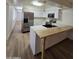 Modern kitchen with stainless steel appliances, eat in bar, and luxury vinyl flooring at 5201 N 61St Dr, Glendale, AZ 85301
