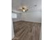 Bright living room featuring new hardwood flooring, ceiling fan, neutral paint, and plenty of natural light at 5201 N 61St Dr, Glendale, AZ 85301