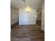 Inviting living room features new hardwood flooring, modern lighting, and neutral paint, ready for your personal touch at 5201 N 61St Dr, Glendale, AZ 85301