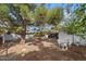 Backyard featuring mature trees that offer shade, and a shed and seating area at 639 N 57Th Pl, Mesa, AZ 85205