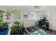 Bedroom featuring natural light, an air conditioner, and a collection of potted plants at 639 N 57Th Pl, Mesa, AZ 85205