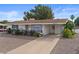 Attractive single-story home featuring a covered carport, desert landscaping, and a well-maintained exterior at 639 N 57Th Pl, Mesa, AZ 85205